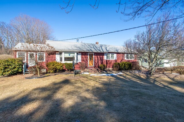 ranch-style home with a front lawn