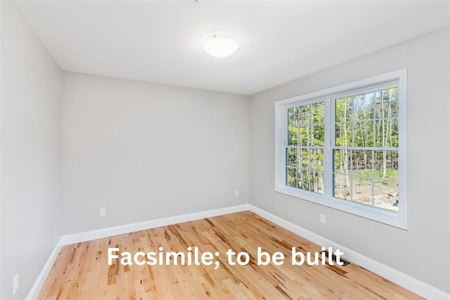 unfurnished room featuring wood finished floors and baseboards