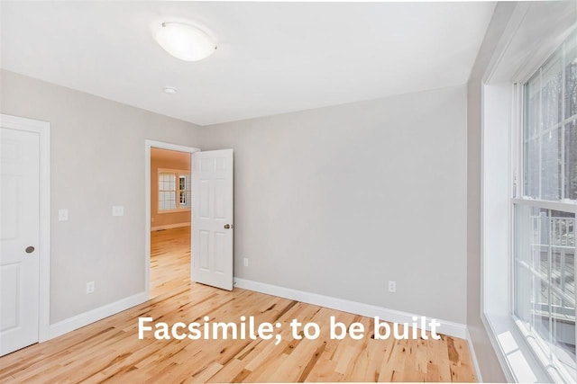 empty room featuring baseboards and wood finished floors