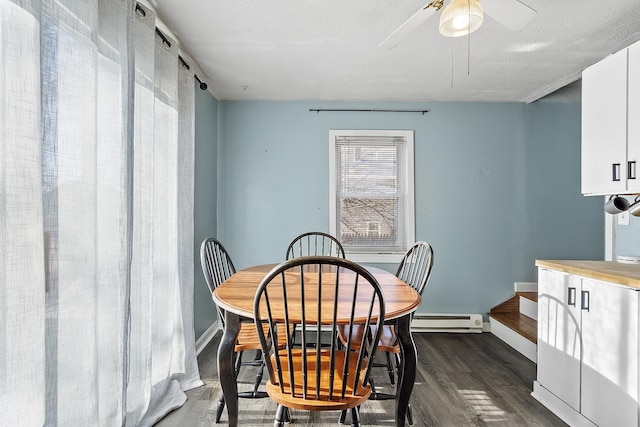 dining area with a baseboard heating unit, baseboards, dark wood-type flooring, and a ceiling fan