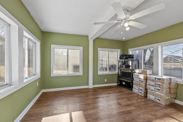 unfurnished sunroom featuring a ceiling fan