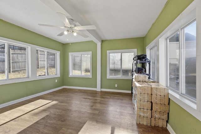 unfurnished sunroom with ceiling fan