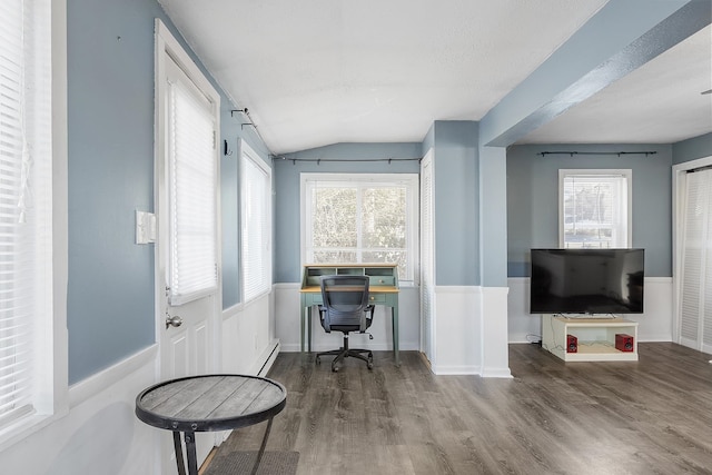 home office featuring vaulted ceiling, wood finished floors, and baseboards