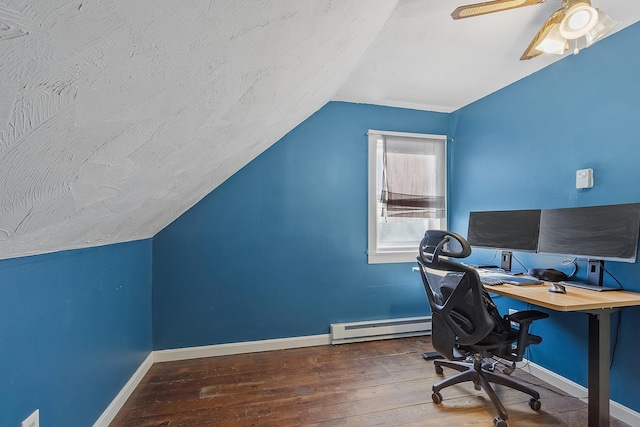 home office with baseboards, vaulted ceiling, baseboard heating, a textured ceiling, and wood-type flooring