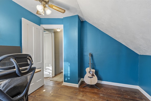 office with baseboards, vaulted ceiling, a ceiling fan, and hardwood / wood-style flooring