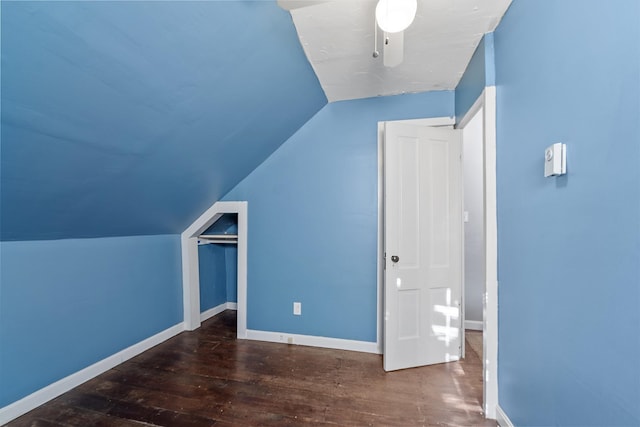 additional living space featuring vaulted ceiling, baseboards, and wood finished floors