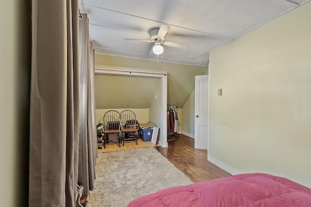 bedroom with a ceiling fan, wood finished floors, and baseboards