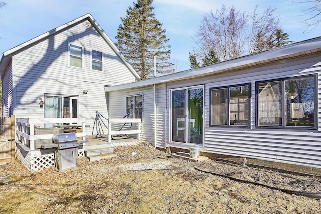 rear view of property with a wooden deck