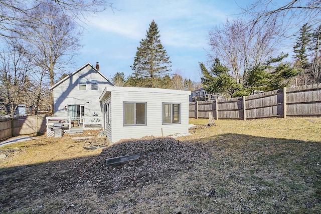 exterior space with a chimney and a fenced backyard