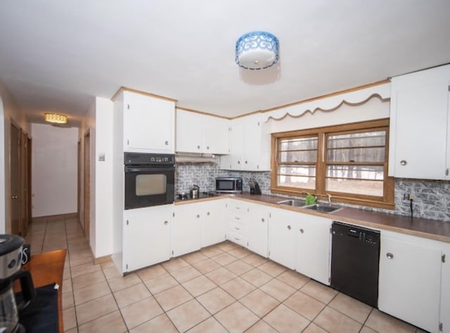 kitchen featuring a sink, tasteful backsplash, black appliances, and light tile patterned floors