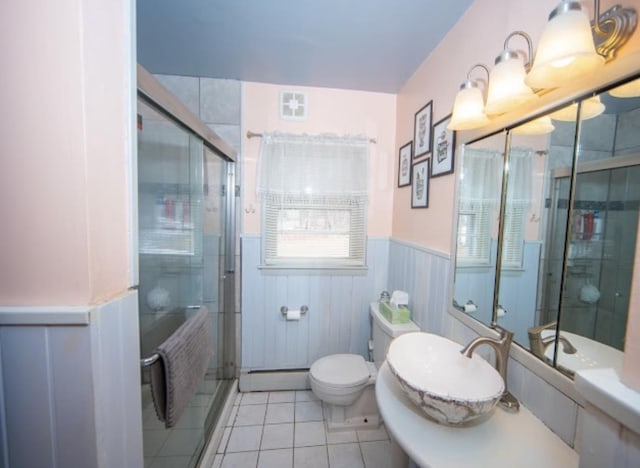 full bathroom featuring visible vents, a wainscoted wall, a baseboard radiator, radiator heating unit, and a shower stall