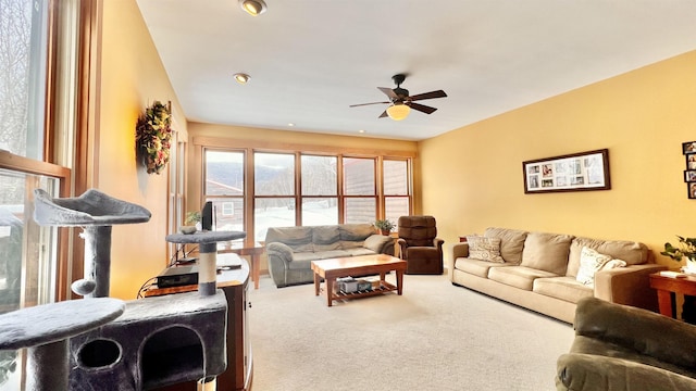 carpeted living area featuring ceiling fan