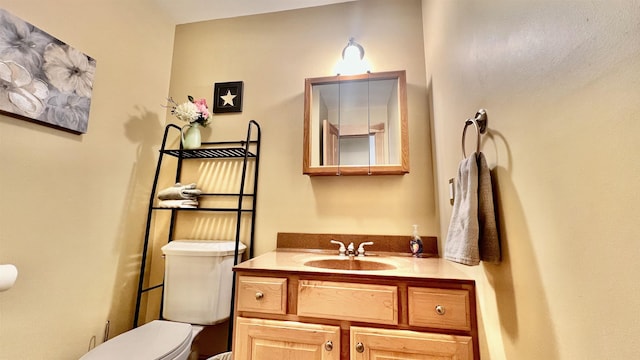 bathroom featuring toilet and vanity