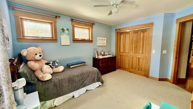 bedroom featuring a ceiling fan, carpet, baseboards, and a closet