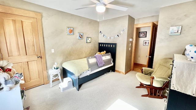 carpeted bedroom featuring baseboards and ceiling fan