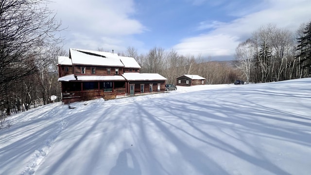 snow covered property featuring a porch