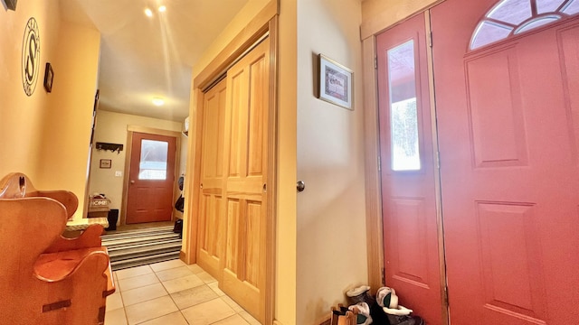 entrance foyer with plenty of natural light and light tile patterned flooring