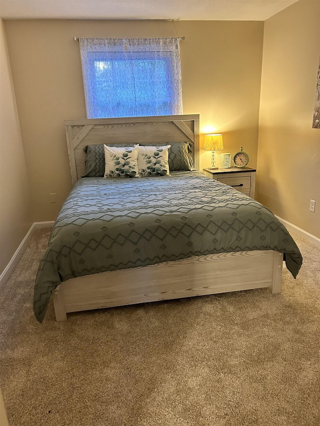 carpeted bedroom featuring baseboards