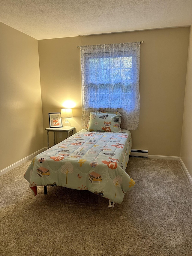 bedroom with a baseboard heating unit, baseboards, a textured ceiling, and carpet flooring