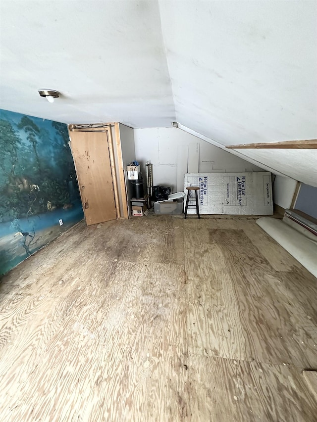 additional living space featuring baseboard heating and lofted ceiling