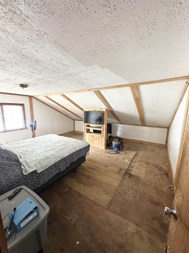 bedroom featuring vaulted ceiling, baseboards, and a textured ceiling