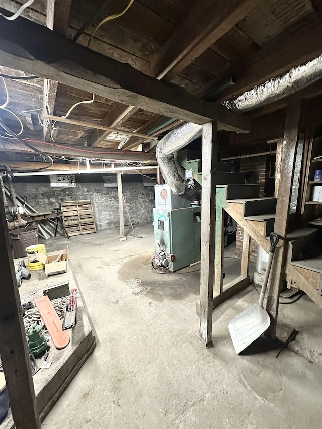 unfinished basement featuring heating unit