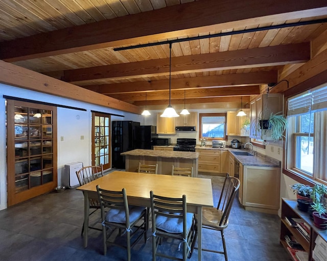 dining space featuring beam ceiling and wooden ceiling