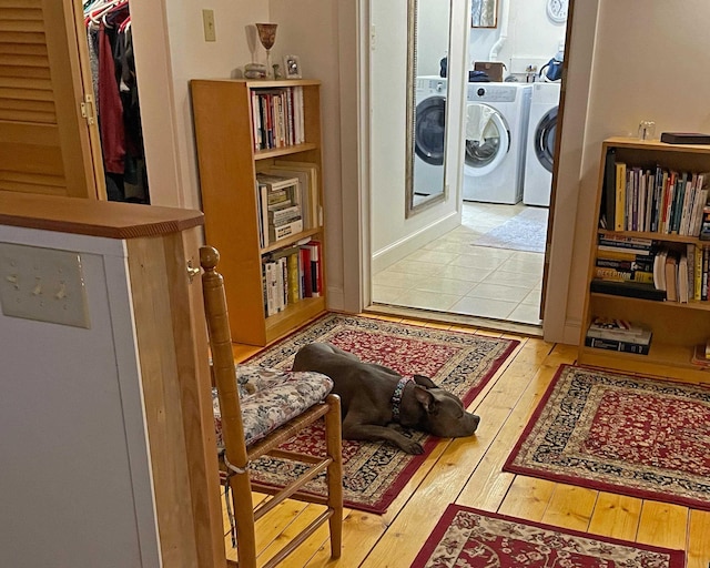 interior space featuring washing machine and clothes dryer and wood-type flooring