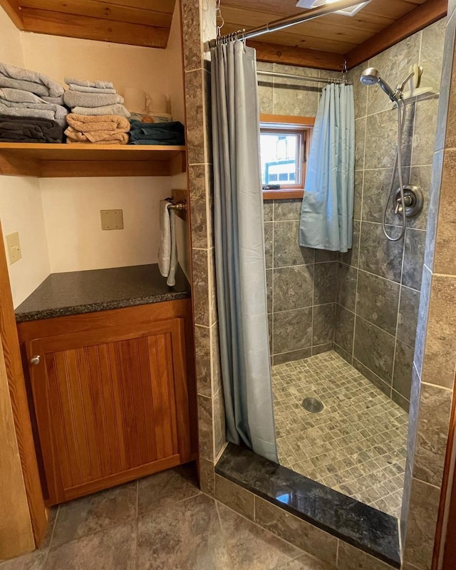 full bathroom with tiled shower and wooden ceiling