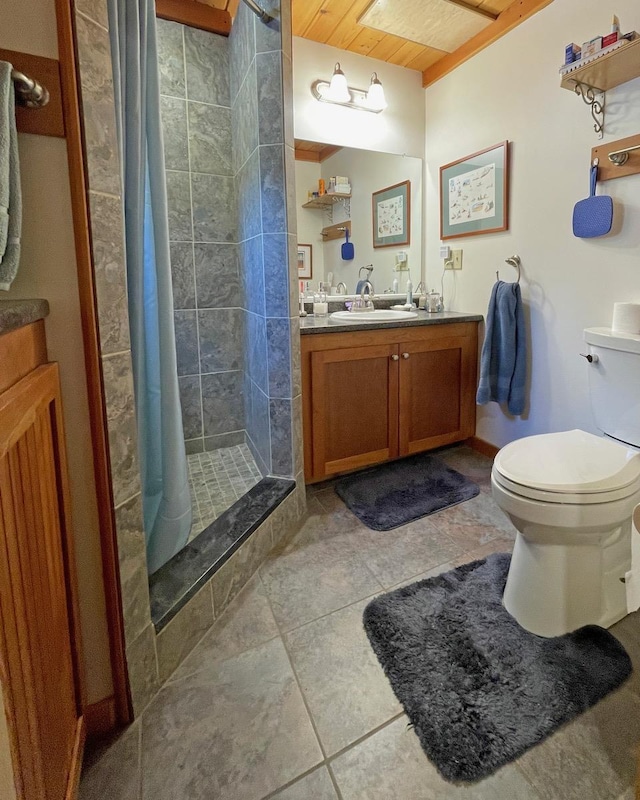 bathroom with vanity, a shower stall, and toilet