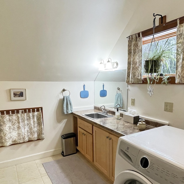 bathroom featuring baseboards, vaulted ceiling, washer / dryer, tile patterned floors, and vanity