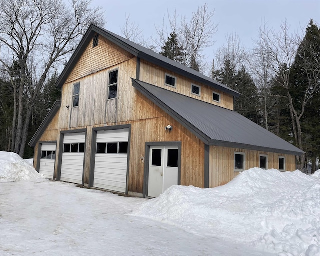 snow covered garage with a garage