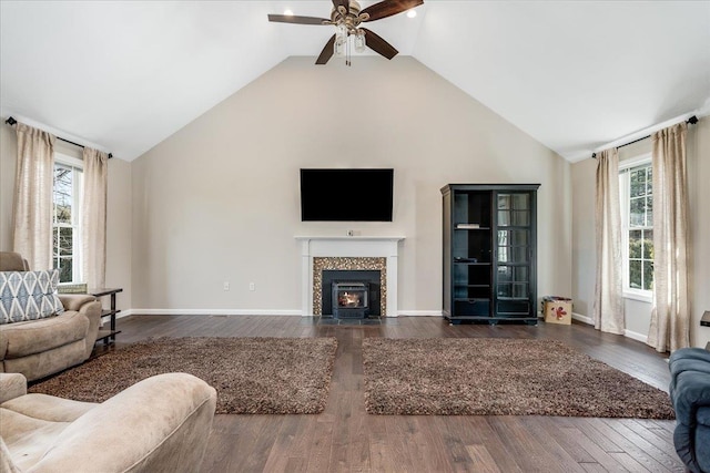 living area with dark wood-style floors, ceiling fan, and baseboards