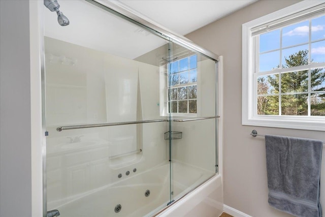 bathroom with shower / bath combination with glass door