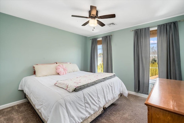 carpeted bedroom featuring baseboards, visible vents, and ceiling fan