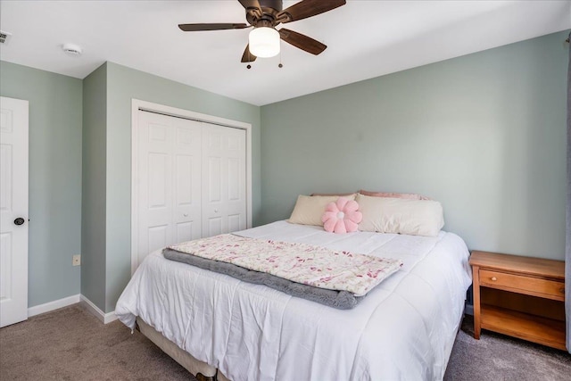 bedroom with visible vents, a ceiling fan, a closet, carpet floors, and baseboards