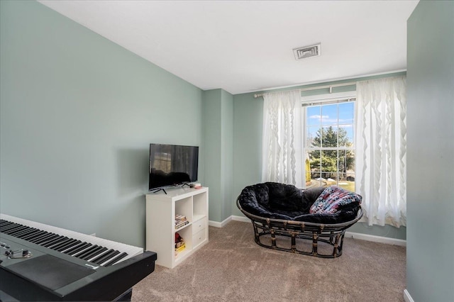 sitting room with visible vents, baseboards, and carpet