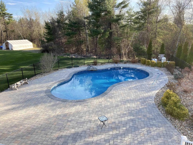 view of swimming pool featuring a fenced in pool, a patio, and fence