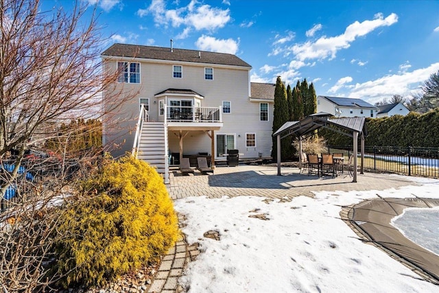 rear view of house with stairs, a patio, and fence