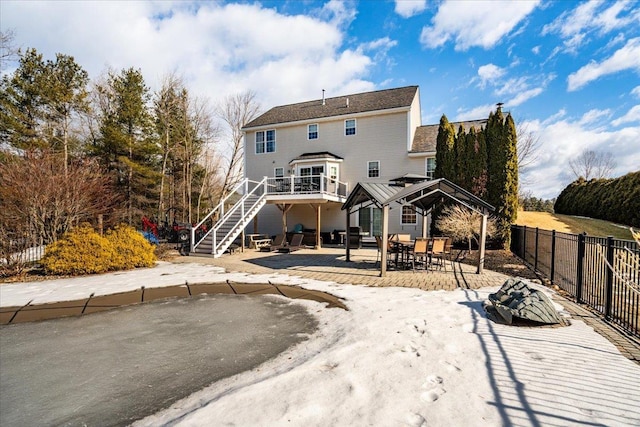 rear view of property with stairway, a patio area, and fence