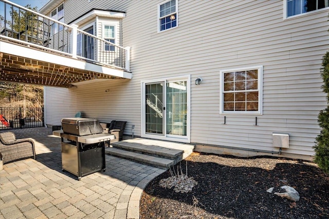 view of patio / terrace featuring a balcony, fence, and grilling area