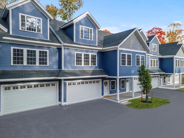 view of front of property with driveway and a shingled roof