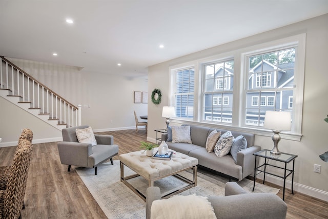 living area featuring stairs, recessed lighting, wood finished floors, and baseboards