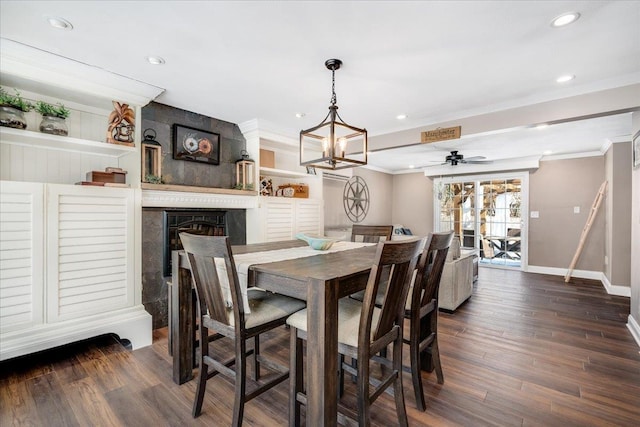 dining space with a large fireplace, crown molding, baseboards, recessed lighting, and dark wood-style floors