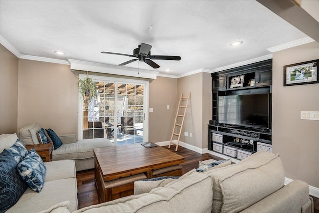 living room featuring wood finished floors, baseboards, and ornamental molding