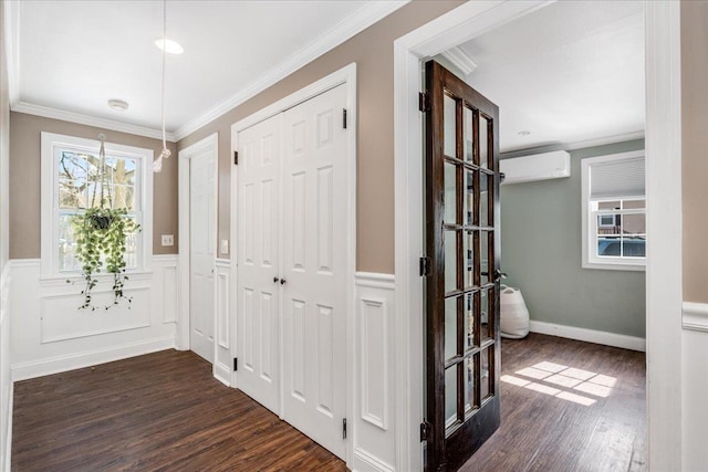 hallway featuring dark wood finished floors, a wainscoted wall, a wall mounted air conditioner, and ornamental molding