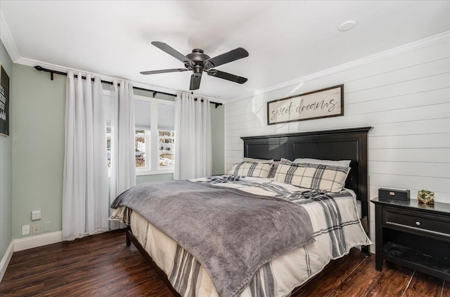 bedroom featuring ornamental molding, baseboards, ceiling fan, and wood finished floors