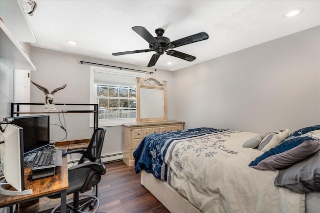 bedroom featuring dark wood-type flooring, a ceiling fan, a baseboard heating unit, a textured ceiling, and recessed lighting