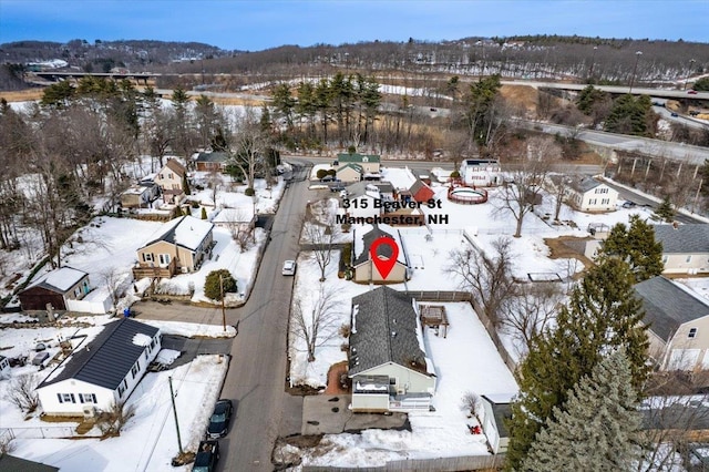 snowy aerial view featuring a residential view