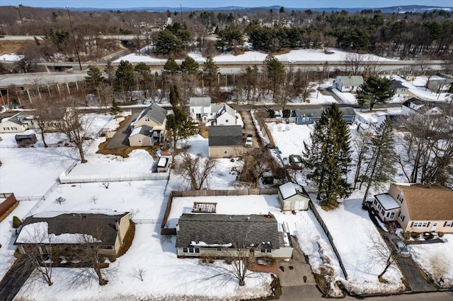 snowy aerial view featuring a residential view